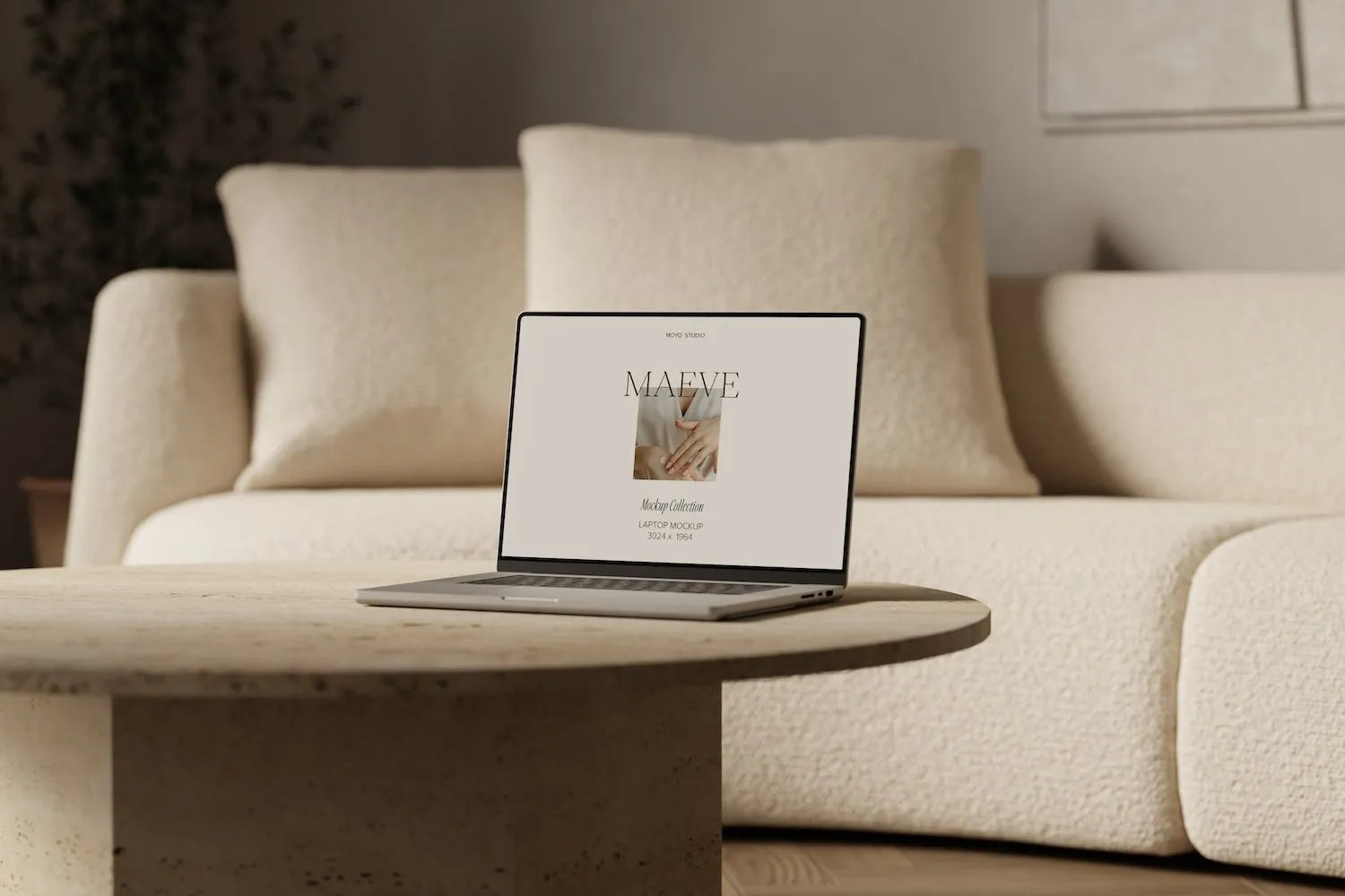 Laptop on table with couch in background